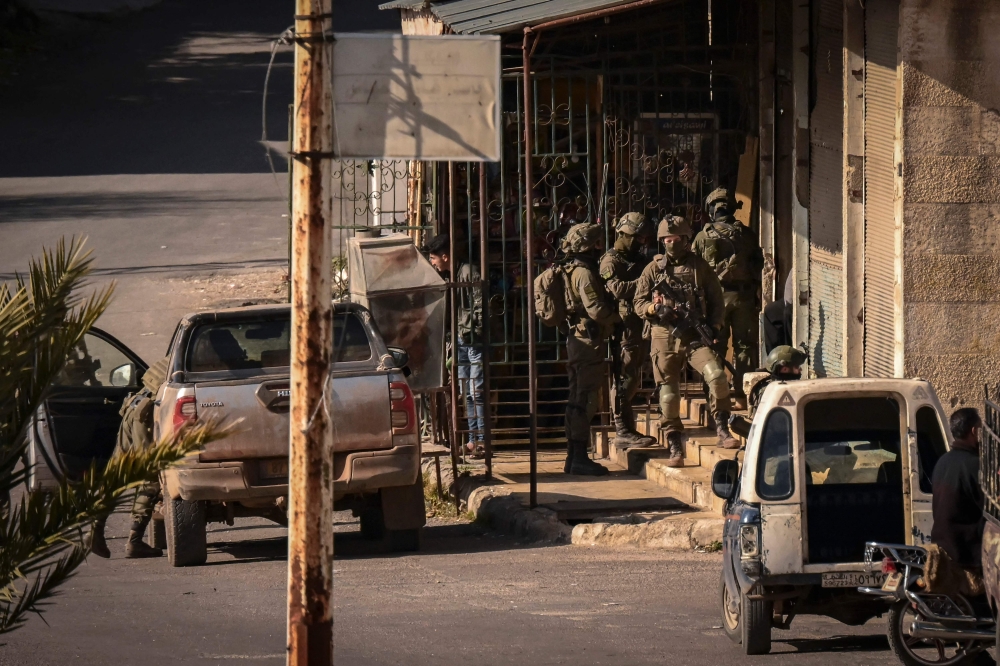 Israeli soldiers patrol in the Syrian town of Jubata al-Khashab. — AFP pic