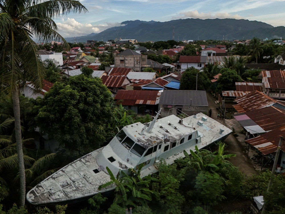 A drone view of a coast guard ship that was carried about five kilometres inland to the city centre of Banda Aceh, during the Indian Ocean tsunami, December 21, 2024. — Reuters pic