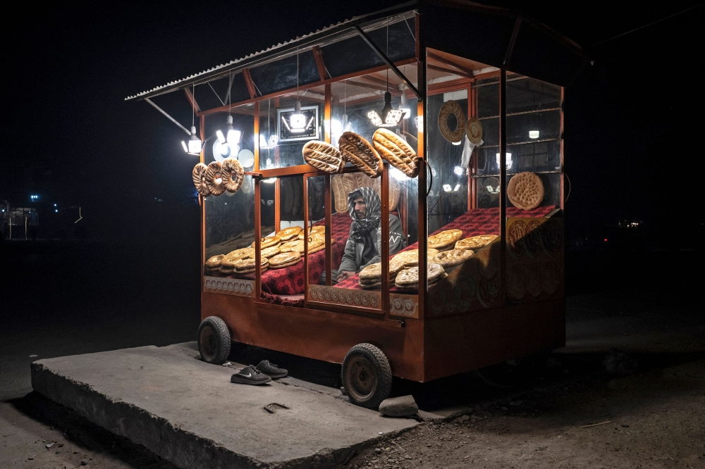 An Afghan vendor selling traditional flatbreads locally known as Naan, as he waits for customers along a roadside in Kabul December 15, 2024. — AFP pic