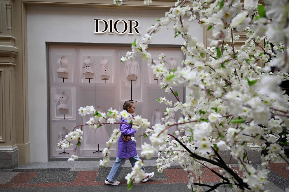 A woman walks past a closed Dior boutique at the GUM department store in downtown Moscow on May 27, 2022. — AFP pic