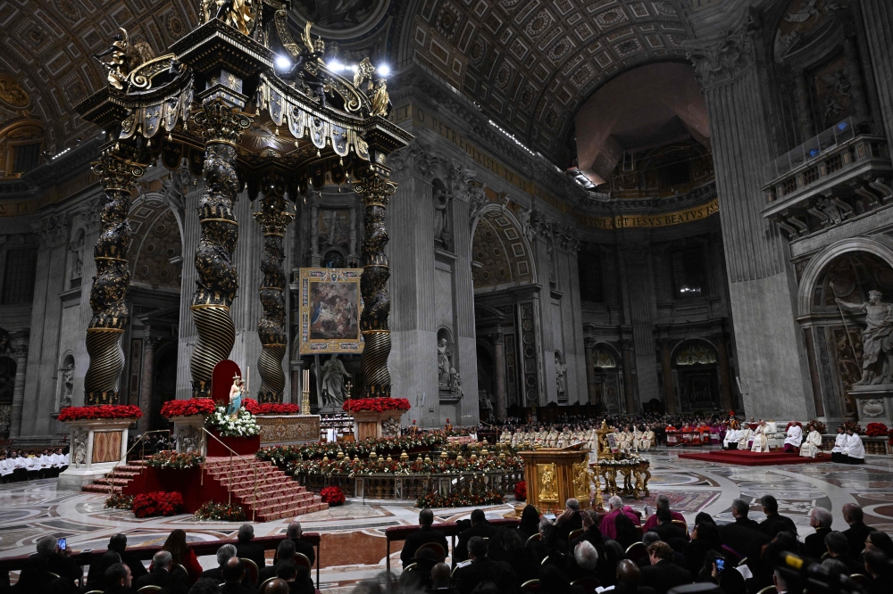 A general view shows St Peter's Basilica during the Christmas Eve mass in the Vatican on December 24, 2024. Over the next 12 months, pilgrims will pass through the large and imposing bronze door, which is normally closed, by tradition benefiting from a ‘plenary indulgence’, a type of forgiveness for their sins.— AFP pic