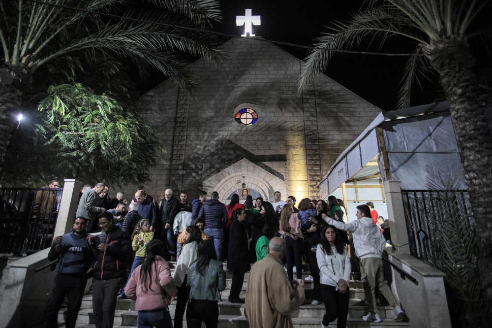 Worshippers walk outside after Christmas Eve mass at the Roman Catholic Church of the Holy Family Church in the Zaytoun neighbourhood of Gaza City on December 24, 2024, amid the ongoing war in the besieged Palestinian territory between Israel and Hamas. — AFP pic