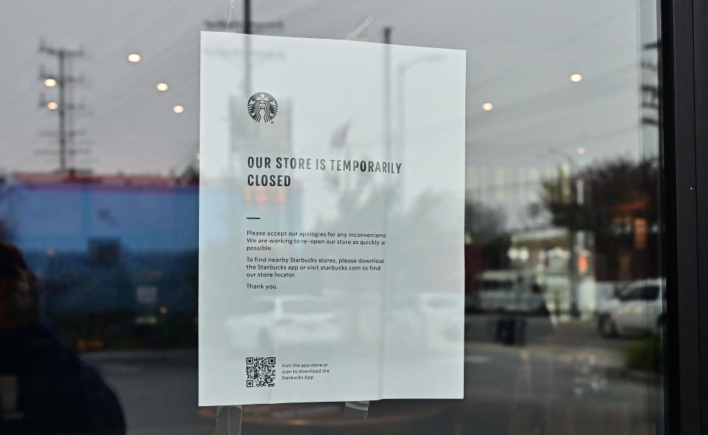 A sign at a Starbucks informs customers of temporary closure as workers were due to picket in front of the temporarily closed store on December 24, 2024 in Los Angeles, California, as the nationwide strike continues for the fifth day at various locations across the country. — AFP pic