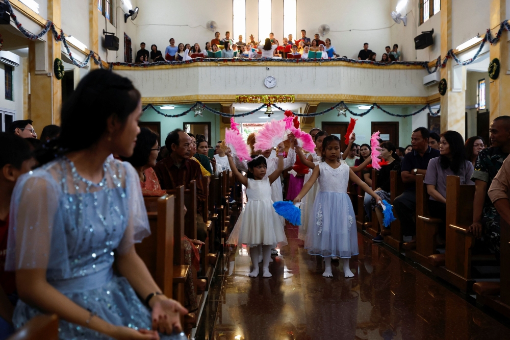 Catholic children take part in a mass during Christmas celebrations at the Sacred Heart Catholic Church, ahead of the 20th anniversary of the Indian Ocean earthquake and tsunami, in Banda Aceh, Aceh December 25, 2024. — Reuters pic  