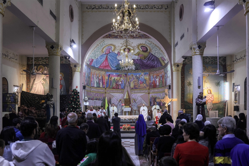 Worshippers attend the Christmas Eve mass at the Roman Catholic Church of the Holy Family Church in the Zaytoun neighbourhood of Gaza City on December 24, 2024, amid the ongoing war in the besieged Palestinian territory between Israel and Hamas. — AFP pic