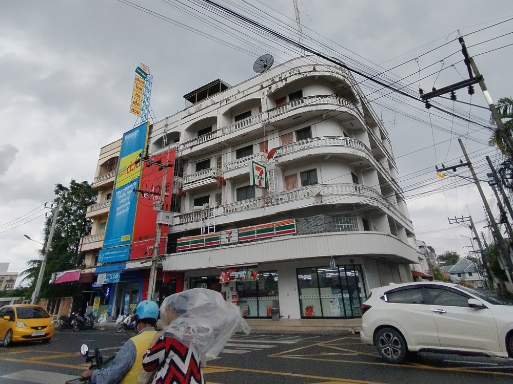 A busy street corner in Hat Yai, Thailand, featuring a multi-storey building with a 7-Eleven store on the ground floor. — Picture by Muhammad Yusry