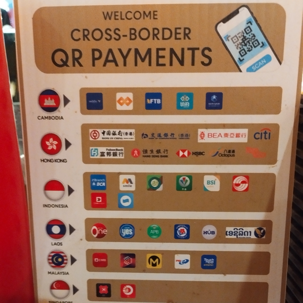 A sign in Hat Yai promoting cross-border QR payment options, featuring banking and payment systems from various countries like Cambodia, Hong Kong, Indonesia, Laos, Malaysia, and Singapore.  — Picture by Muhammad Yusry