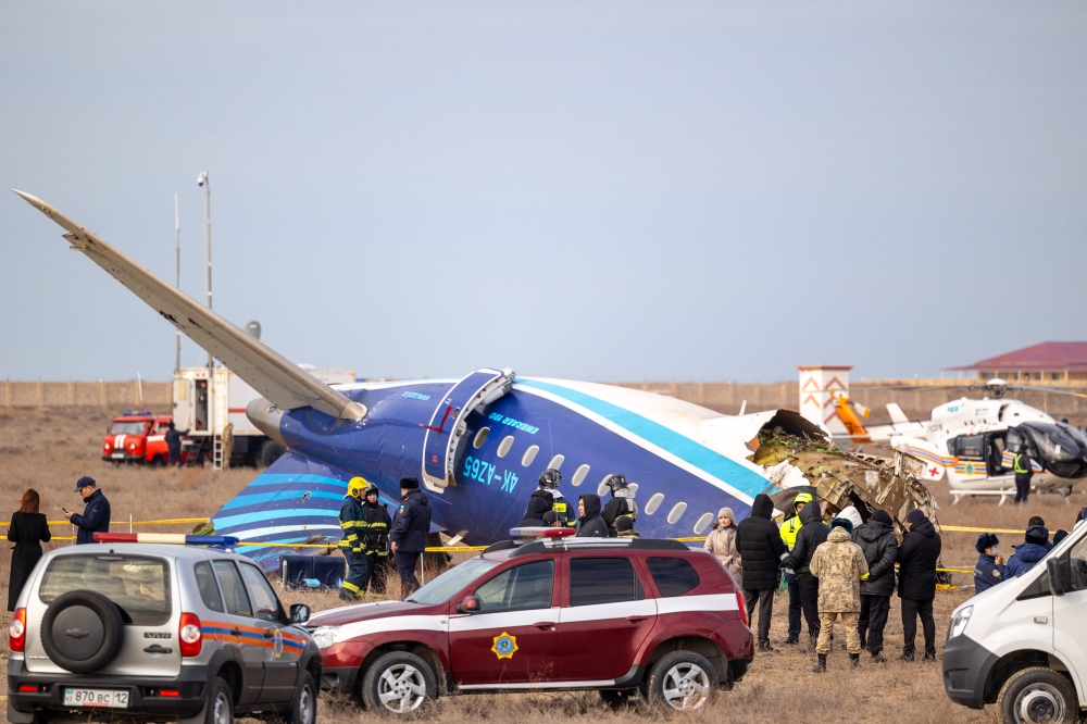 Emergency specialists work at the crash site of an Azerbaijan Airlines passenger jet near the western Kazakh city of Aktau. — AFP