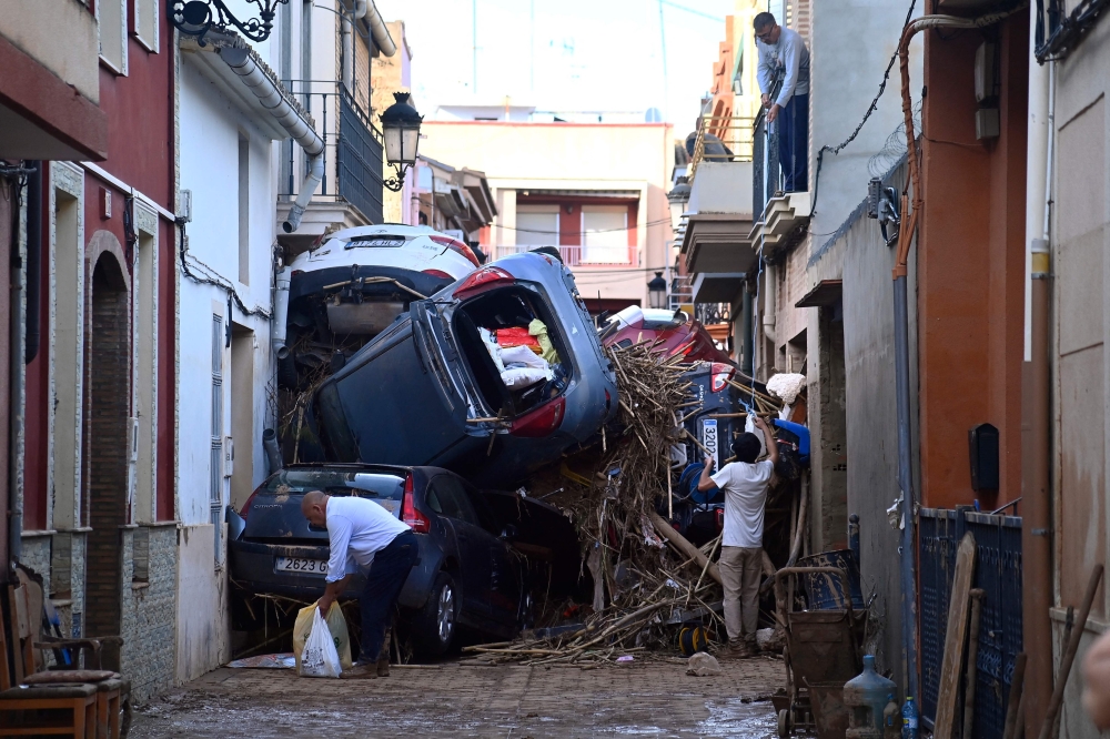 Debris fill a street, on November 1, 2024, after a flooding devastated the town of Paiporta, in the region of Valencia, eastern Spain. — AFP pic