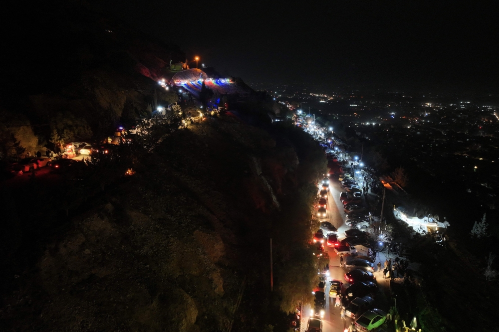 An aerial view shows Syrians gather at Mount Qasioun overlooking Damascus on December 26, 2024. — AFP pic