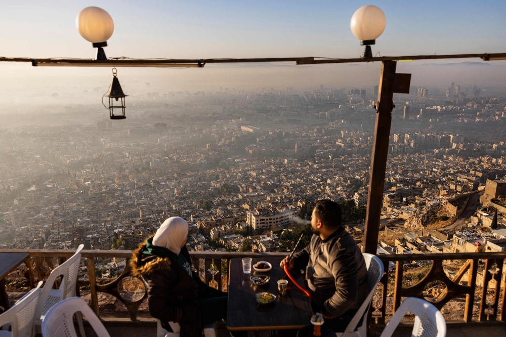 People at a coffee shop on Mount Qasioun. — AFP pic