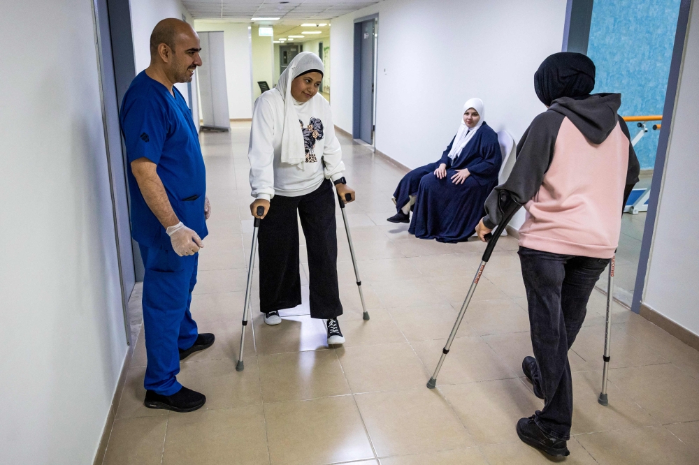 Palestinian girls who were injured in the Gaza Strip during the war between Israel and Hamas, receive rehabilitation care at a hospital in Abu Dhabi December 12, 2024. — AFP pic