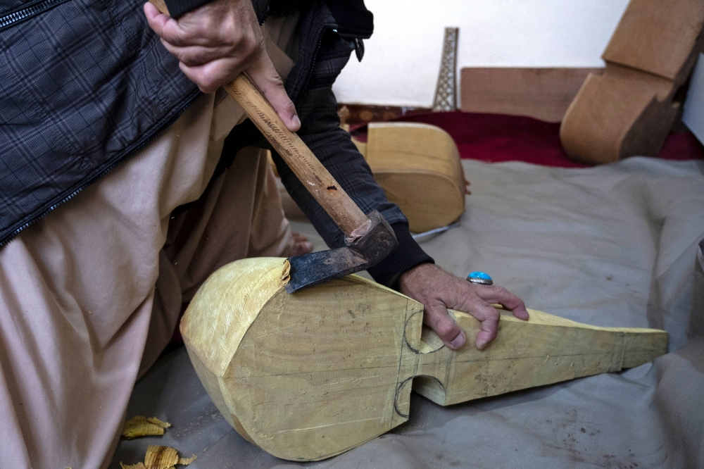 Sakhi has crafted two rubabs a month for decades, and he refuses to set down his tools even as a Taliban crackdown strangles music in Afghanistan. — AFP pic