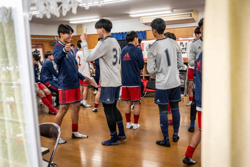 Members of Ryutsukeizai University Kashiwa High School football club chat after a meeting following a training session in Kashiwa city of Chiba prefecture December 13, 2024. — AFP pic