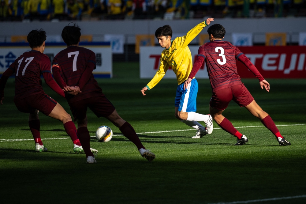 Players compete during the high school football match between Tokyo's Teikyo (yellow) and Kyoto's Kyoto Tachibana in the 103rd All Japan high school football tournament at the National Stadium of Tokyo December 28, 2024. — AFP pic