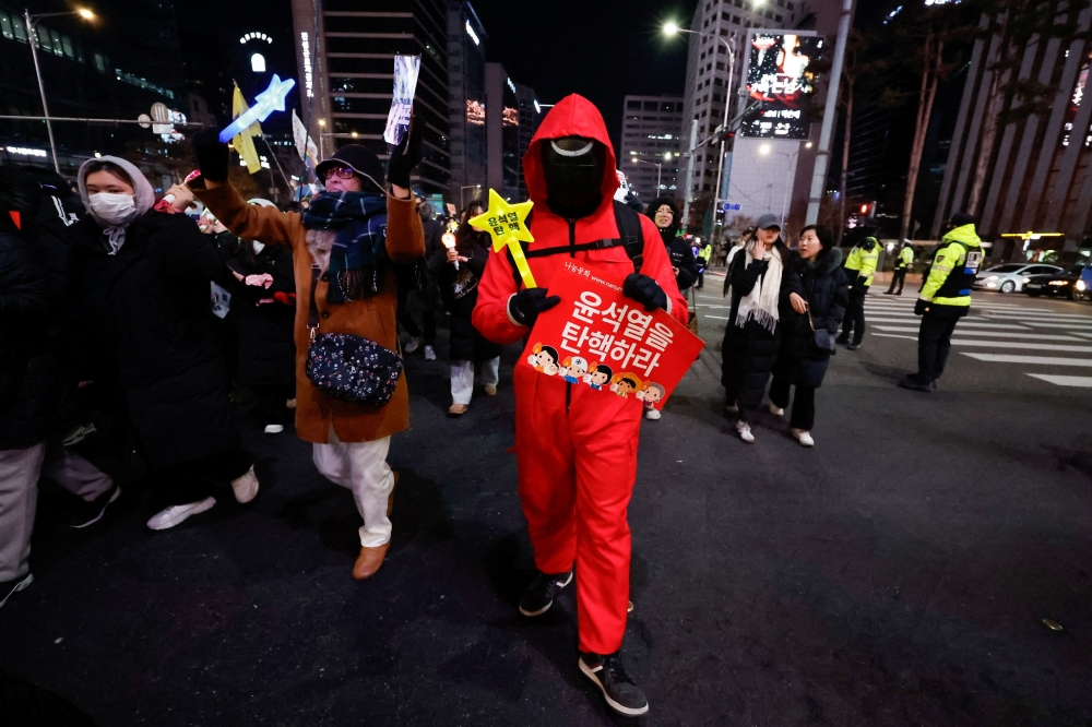 A protester in a rlly against South Korea's impeached President Yoon Suk Yeol dressed as a character from the popular ‘Squid Game’ series. — Reuters