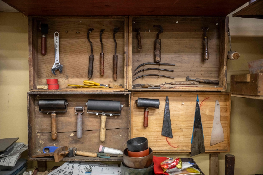 Tools hang on a wall by the desk of Japanese lacquerware maker Takaho Shoji at the Wajima Kirimoto lacquerware studio in Wajima city, Ishikawa prefecture, December 11, 2024. — AFP pic