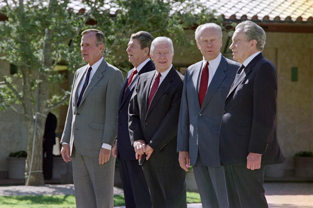 Former US presidents, (from left to right) George Bush, Ronald Reagan, Jimmy Carter, Gerald Ford and Richard Nixon, pose for pictures in front of the Reagan Library in California in1991. — AFP