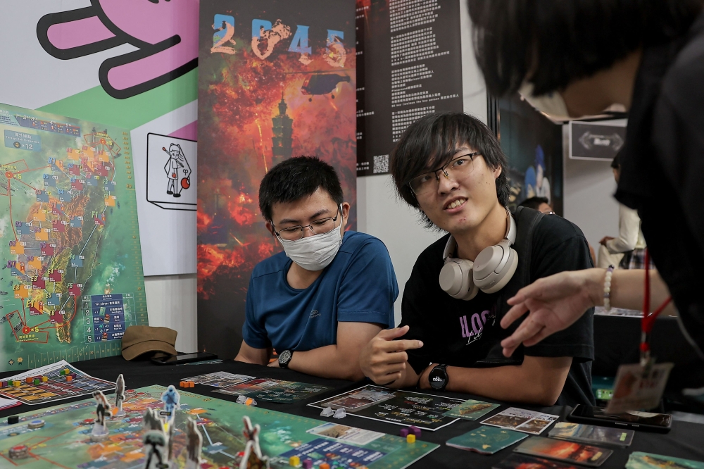 Players test ‘2045’, a new board game by Mizo Games set against the backdrop of armed conflicts around Taiwan, in Taipei September 22, 2024. — Reuters pic  