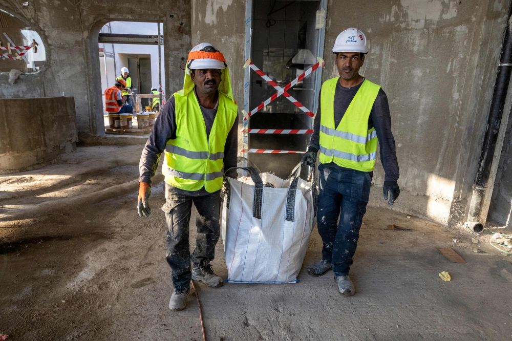 Indian builders work on a construction site in the Israeli coastal city of Tel Aviv.— AFP pic