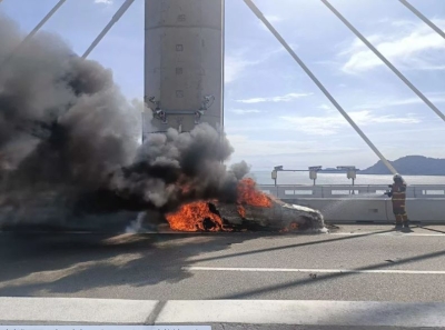 Mercedes crashes and catches fire after hitting car battery left by roadside, causing major traffic jam on Penang's second bridge