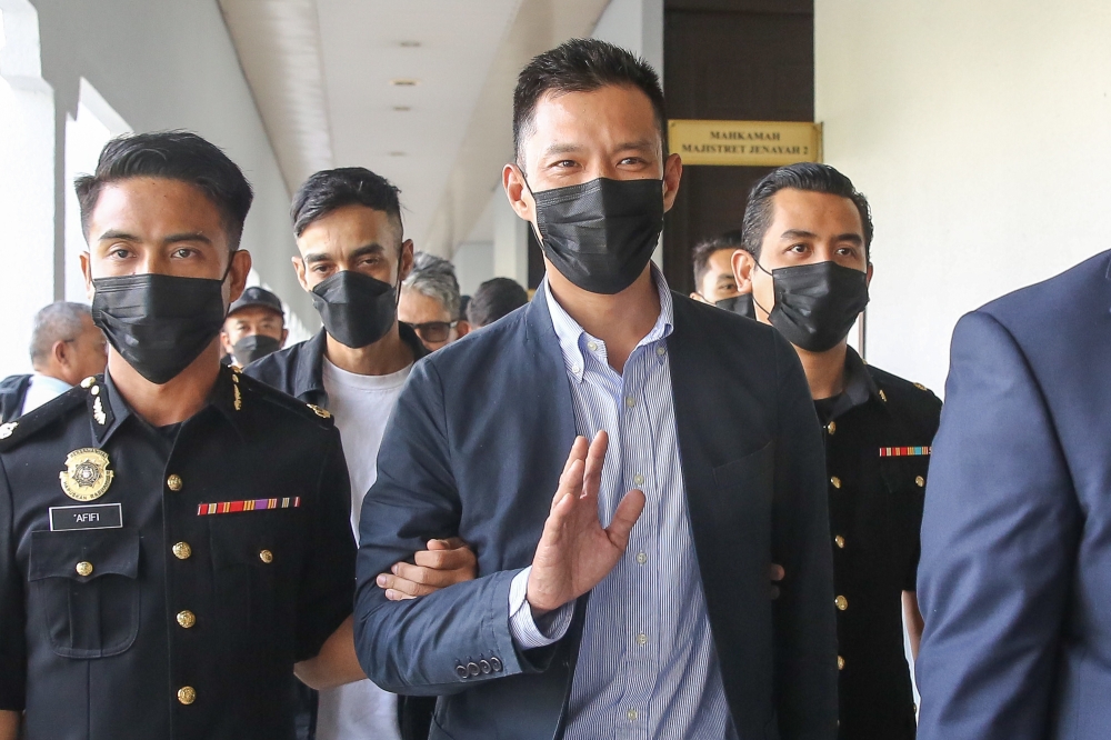 Muhammad Faisal Hamzah (centre) who is the son of Opposition Leader Datuk Seri Hamzah Zainudin is charged with accepting RM100,000 in bribes in 2018. — Picture by Yusof Mat Isa