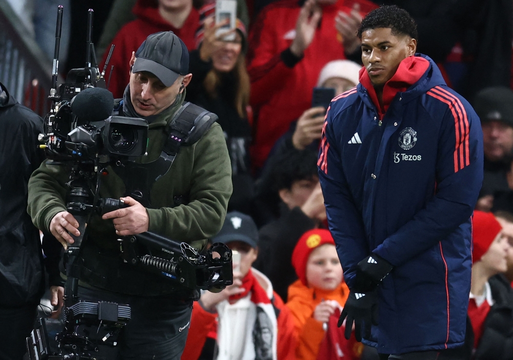 Manchester United's English striker #10 Marcus Rashford warms up ahead of the match. — AFP