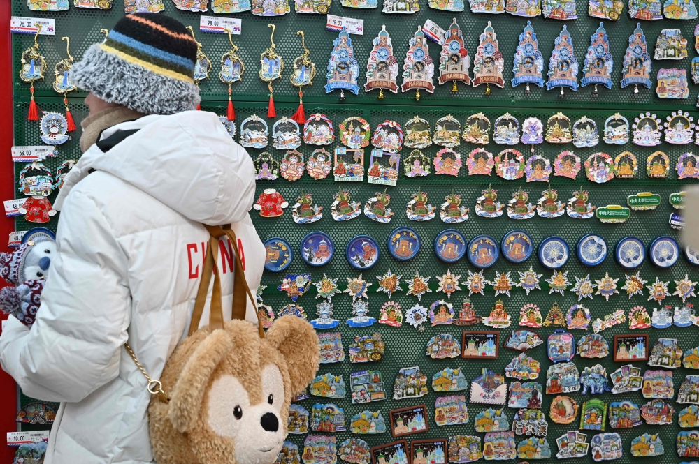 A woman shops for souvenirs in Harbin. — AFP pic