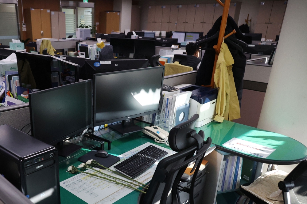 Condolence flowers are laid on the desk of a government official of Jeollanam-do Office of Education, who died in the Jeju Air crash at Muan International Airport, in Muan, South Korea, December 31, 2024. — Reuters pic  