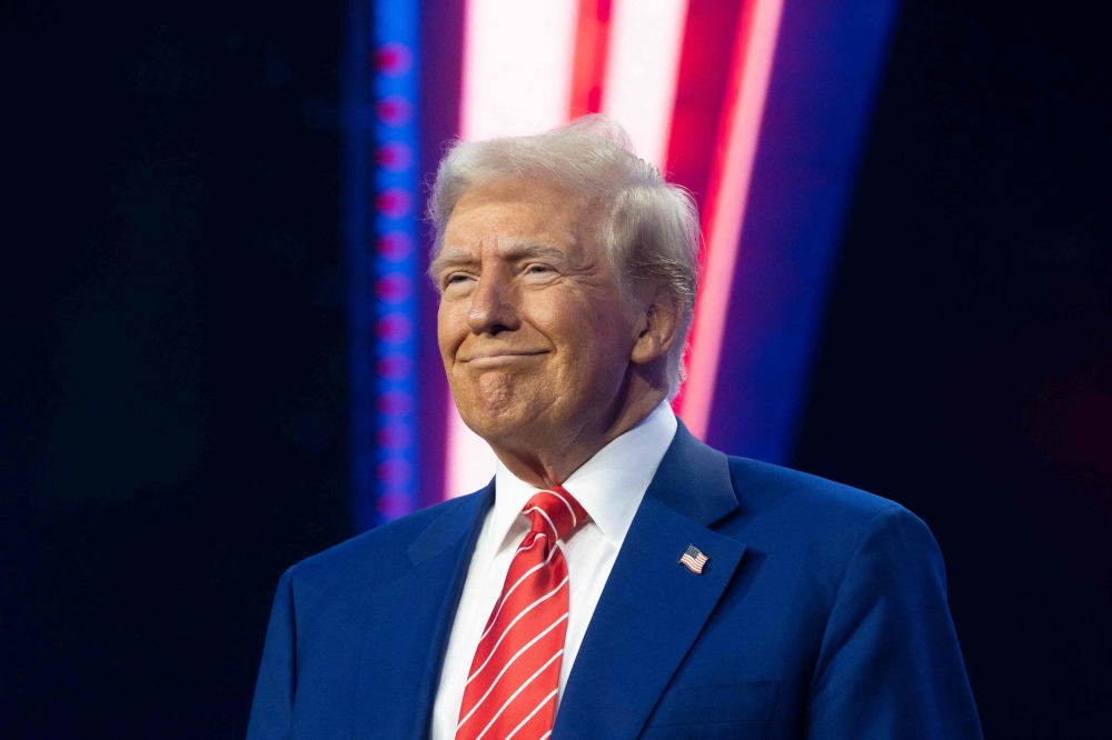 US President-elect Donald Trump smiles during Turning Point USA's AmericaFest at the Phoenix Convention Center on December 22, 2024 in Phoenix, Arizona. — AFP pic