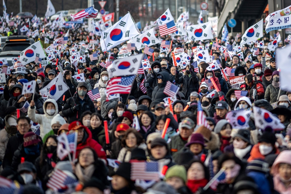 Participants wave US and South Korean flags during a rally to support impeached South Korea’s President Yoon Suk Yeol. — AFP