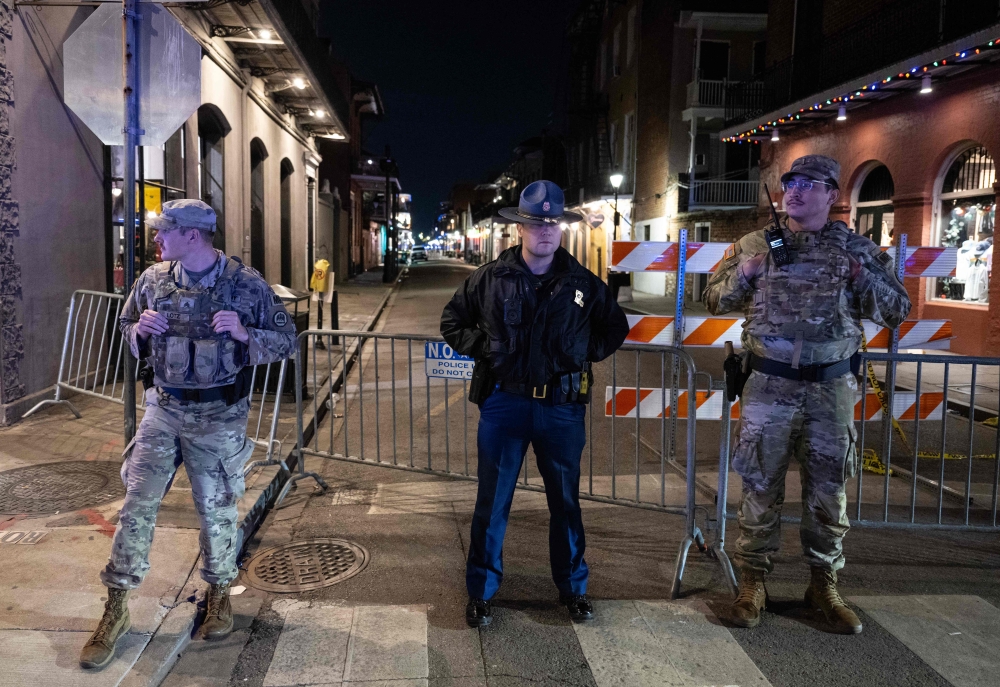 Members of the National Guard and police look on at a blocked off street, a block from Bourbon Street, after at least 15 people were killed during an attack early in the morning on January 1, 2025 in New Orleans, Louisiana. — AFP pic