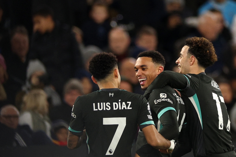 Liverpool's English defender #66 Trent Alexander-Arnold (centre) celebrates scoring the team's fourth goal during the English Premier League football match between West Ham United and Liverpool at the London Stadium, in London on December 29, 2024. — AFP pic