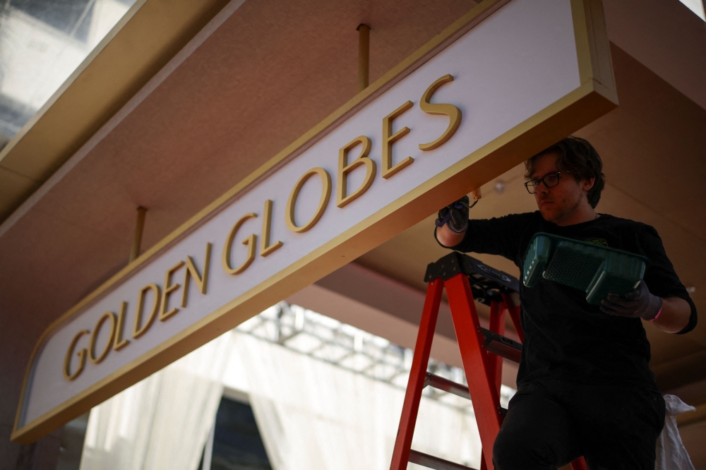 A worker paints a set at the Beverly Hilton in preparation for the Golden Globes and Hollywood's award season, in Beverly Hills, California January 2, 2025. — Reuters pic  