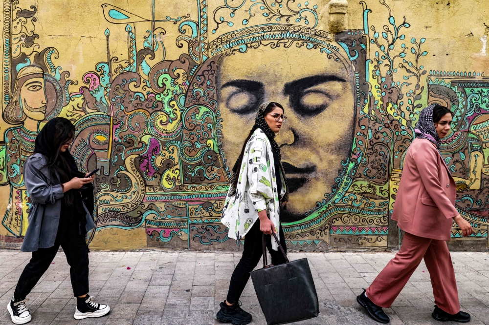 Arabesque patterns and relief faces carved with intricate details and painted in an array of vivid hues of greens, pinks, blues and purples now adorn the walls. — AFP pic   