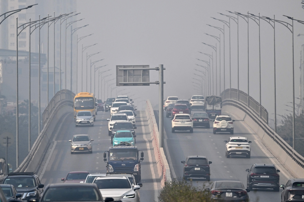 Vehicles are pictured during heavy air pollution conditions in Hanoi on January 2, 2025. — AFP pic