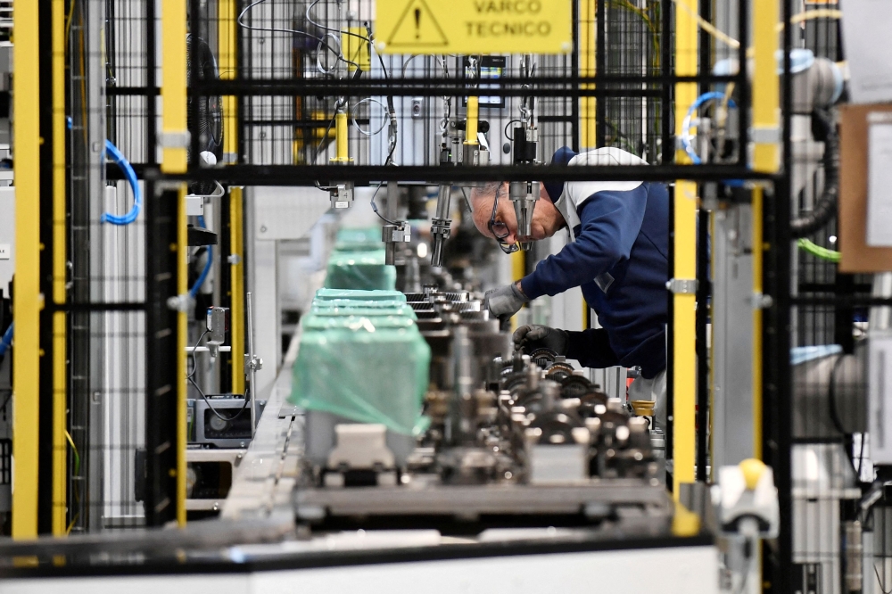 A Stellantis worker stands at work during production at the group's new electrified dual-clutch transmission (eDCT) assembly facility in the Mirafiori complex in Turin April 10, 2024. — Reuters pic