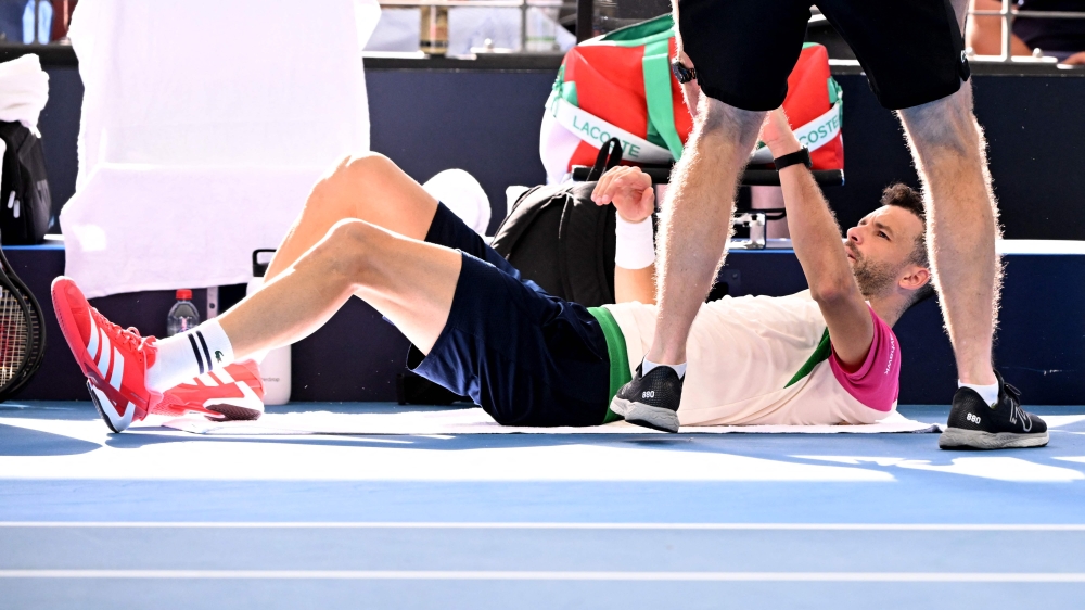 Grigor Dimitrov of Bulgaria receives treatment during the men;s singles semi-final match against Jiri Lehecka of the Czech Republic at the Brisbane International tennis tournament in Brisbane January 4, 2025. — AFP pic