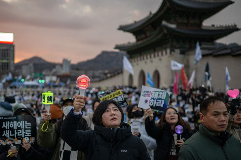 People chant slogans during a rally to protest against impeached South Korea's president Yoon Suk Yeol. — AFP