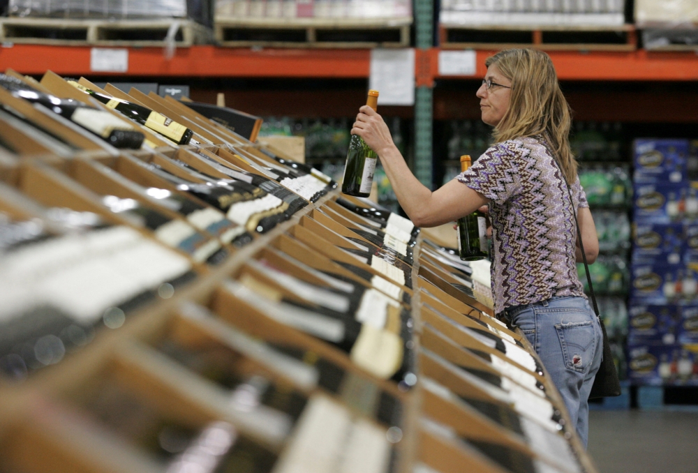 A shopper selects bottles of wine at the Costco Warehouse in Arlington, Virginia, May 29, 2008. — Reuters pic