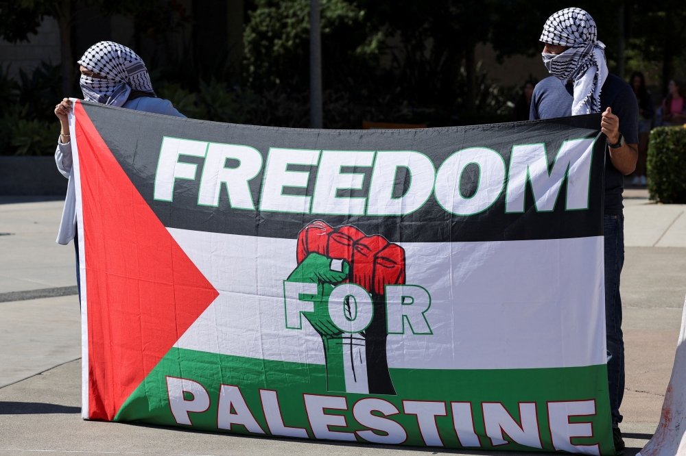 People hold a banner to denounce Israel for what is described as ‘one year of genocide on the people of Gaza’ in a demonstration at the University of California, in the US on October 7, 2024. — Reuters file pic