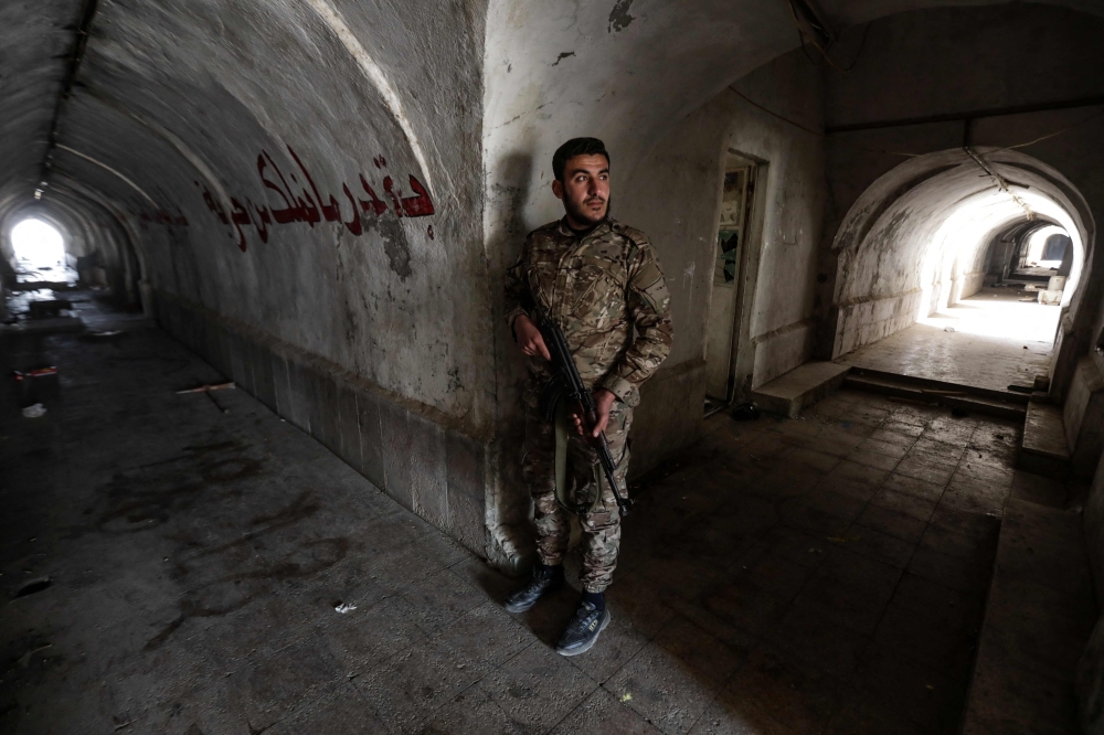 A fighter affiliated with Syria's new administration stands inside a tunnel, inside the abandoned Syrian Republican Guard (SRG) base near Damascus on January 4, 2025. — AFP pic