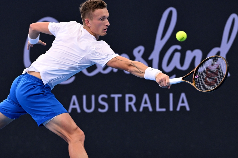 Jiri Lehecka of the Czech Republic his a return during the men? singles semi-final match against Grigor Dimitrov of Bulgaria at the Brisbane International tennis tournament in Brisbane January 4, 2025. — AFP pic