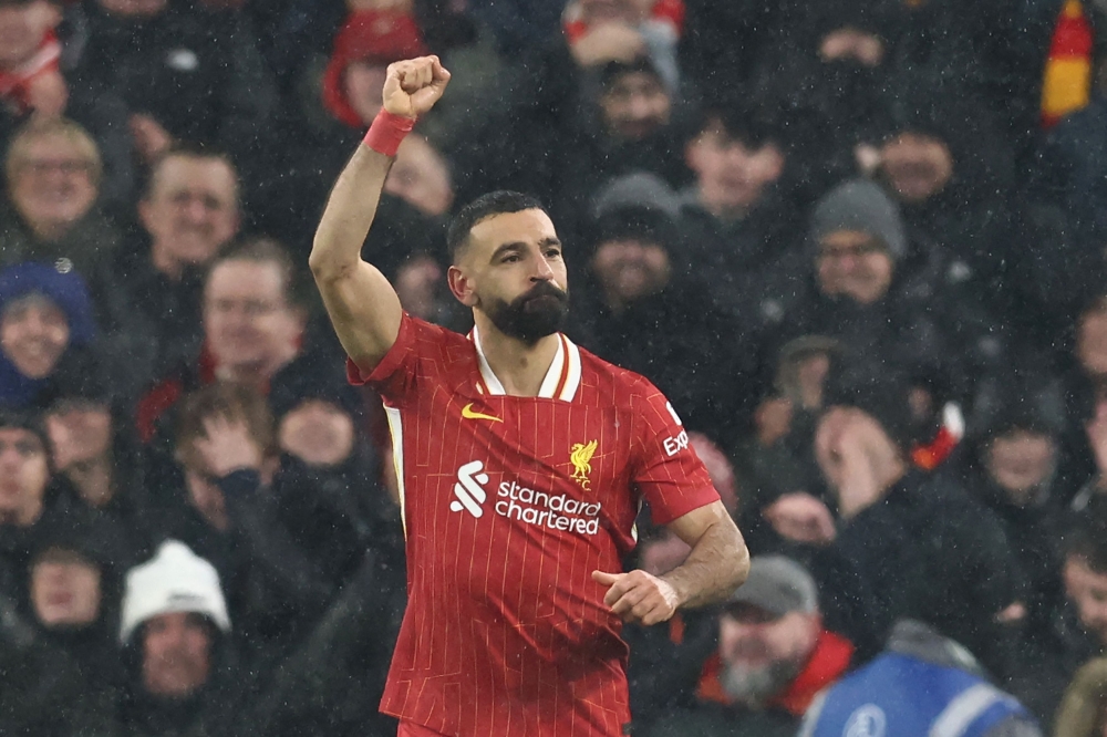 Liverpool’s Mohamed Salah celebrates after scoring their second goal from the penalty spot. — AFP