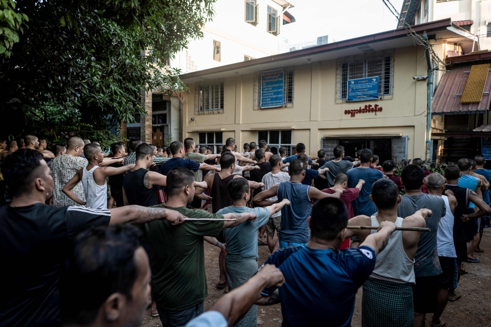 This photo taken on December 14, 2024 shows recovering drug addicts exercising during a rehabilitation program at the Metta Saneain drug addict rehab centre in Yangon. — AFP pic