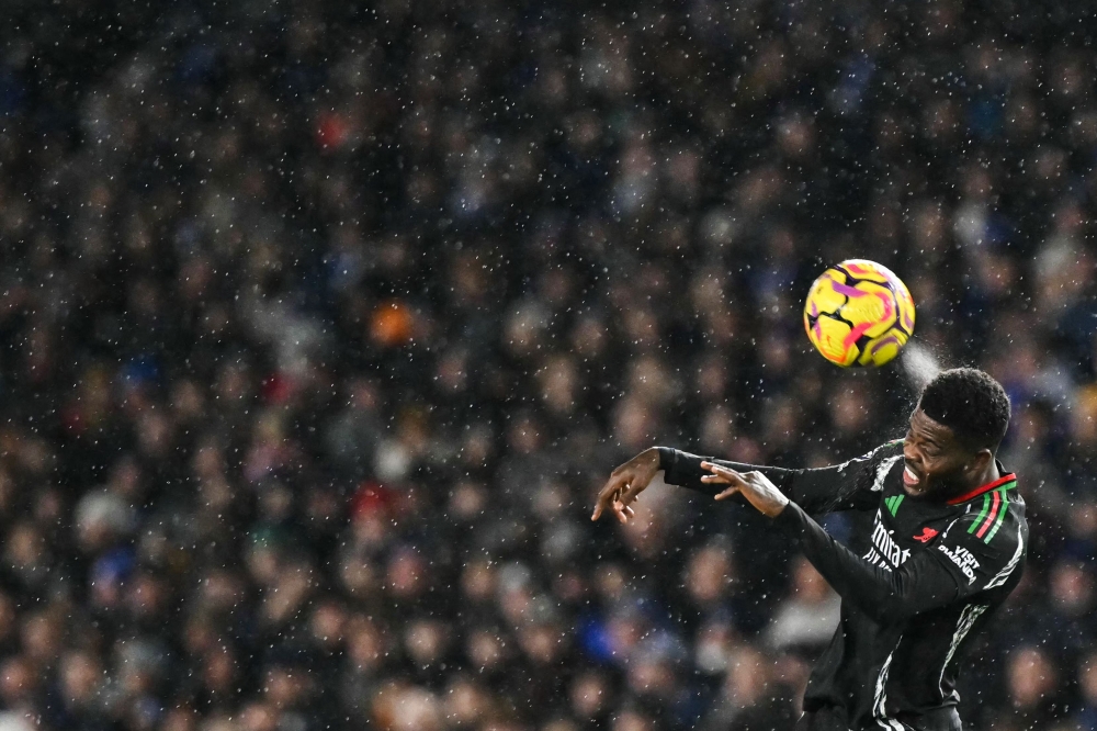 Arsenal's Ghanaian midfielder Thomas Partey heads the ball during the English Premier League football match between Brighton and Hove Albion and Arsenal at the American Express Community Stadium in Brighton, southern England on January 4, 2025. — AFP pic