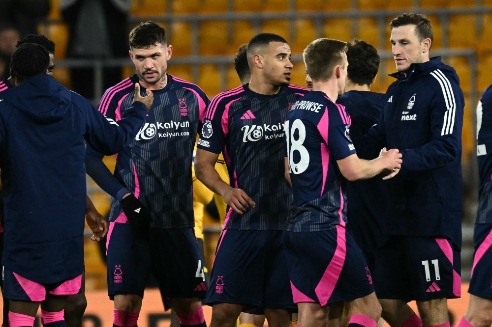 Nottingham Forest’s Chris Wood (right) and teammates celebrate their win on the pitch. — AFP