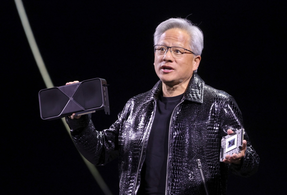 Nvidia CEO Jensen Huang holds a new Nvidia GeForce RTX 5090 graphics card at CES 2025 in Las Vegas, Nevada, US on January 6, 2025. —Reuters pic