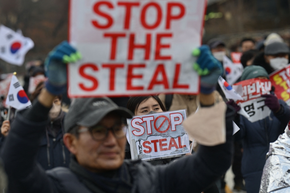 Supporters of impeached South Korea president Yoon Suk Yeol hold 