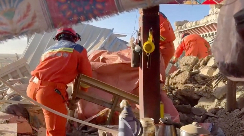 Rescue workers searching through the rubble. — Reuters pic/Tibet Fire and Rescue